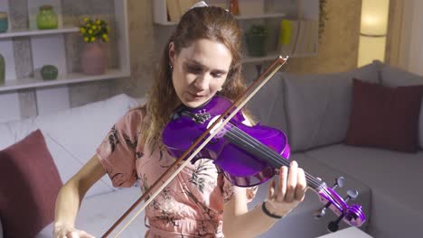 Girl-violinist-gives-violin-concert-at-home.-Music-concept.